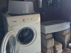 a washing machine sitting next to a washer at Villa Panno, posto romantico! in Serre