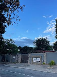a building with a sign on the side of a street at Dreamwood Guest House in Nelspruit