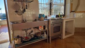 a kitchen with a sink and a stove at Villa Panno, posto romantico! in Serre