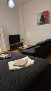 a living room with a bed and a couch at Downtown Chalet in Braunschweig in Braunschweig