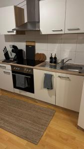 a kitchen with a sink and a stove at Downtown Chalet in Braunschweig in Braunschweig