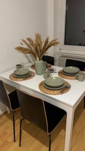 a white table with plates and dishes on it at Downtown Chalet in Braunschweig in Braunschweig +20 photos