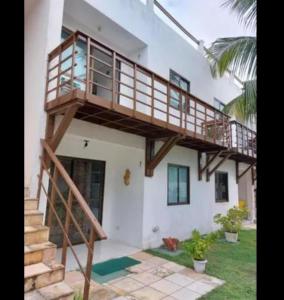 a house with a staircase on the side of it at Apartamento pé na areia na praia de enseadas dos corais-Gaibu, em frente as piscinas naturais in Cabo de Santo Agostinho +13 photos