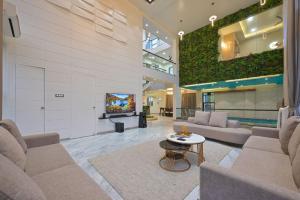 a large living room with couches and a tv at Saanjh Villa 6 bhk in Khamshet