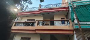 a building with balconies on the side of it at Manju house in Jhūsi