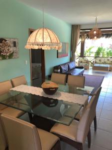 a living room with a glass table and chairs at Fleixeiras Eco Residence in Trairi