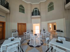 a room with tables and chairs in a building at Four Stars Residence in Dubai