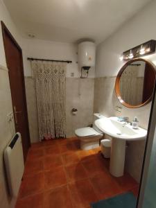 a bathroom with a sink and a toilet and a mirror at Casa Malen in Valdealgorfa