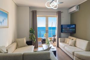 a living room with two couches and a view of the ocean at Cavo Paradise in Sarandë
