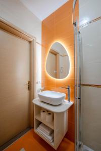 a bathroom with a sink and a mirror at Cavo Paradise in Sarandë +25 photos