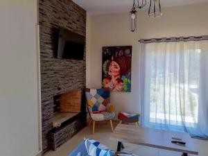 a living room with a couch and a fireplace at Nana's Luxury House in Nafpaktos