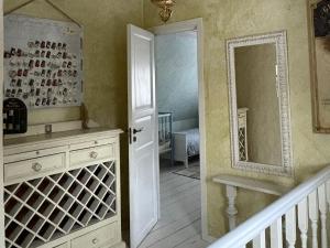 a bathroom with a mirror and a sink and a door at House in the City in Tallinn +43 photos