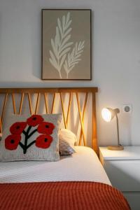 a bedroom with a bed with red flowers on it at Residence Germot - Maison et Appartements design proche Thermes in Vichy +147 photos