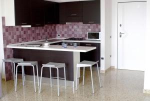 A kitchen or kitchenette at Le Murrine Frontemare Apartment Seaview