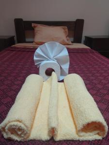 a plate of food on a bed with bread at OkiDoki Cusco Hostal in Cusco