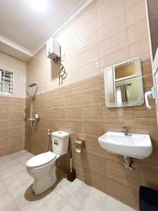 a bathroom with a toilet and a sink at Cherryhomes at Mbezi Juu in Dar es Salaam +17 photos