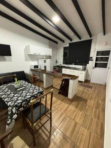 a living room with a table and a large screen tv at Complejo PARAÍSO CHAPADMALAL in Chapadmalal +32 photos