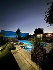 a swimming pool in a yard at night at Complejo PARAÍSO CHAPADMALAL in Chapadmalal