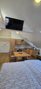 a room with a bed and a table and a tv at lovely apartment in Oberpilsbach