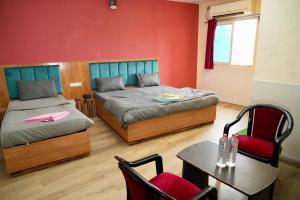 Postel nebo postele na pokoji v ubytování Nirmalya Guest House