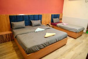 Postel nebo postele na pokoji v ubytování Nirmalya Guest House