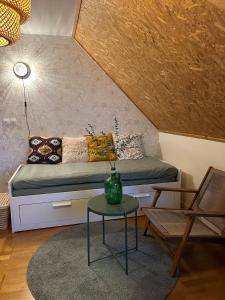 a living room with a couch and a table at La Maison Mimosa - Espace, Confort et Proche Plage in Portbail +8 photos