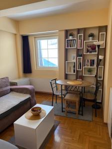 a living room with a couch and a table at Suncani apartman 36, Brzece in Brzeće