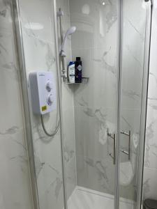 a bathroom with a shower with a glass door at Luxury Studio in Victoria, 7 minutes walk to Victoria Station, Room 1 in London