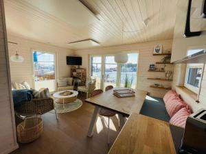 a living room with a couch and a table at Hausboot Lillemor Burgtiefe in Fehmarn