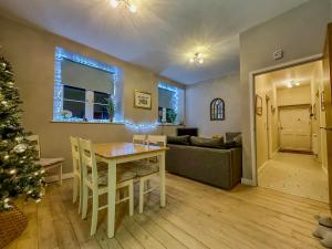 a living room with a table and a christmas tree at Cotswold Chapel, sleeps up to 5 in kingsize beds in Chipping Norton