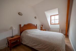 a bedroom with a large bed and a window at Chalet d'Estive in Cauterets