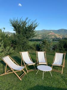 two chairs and a table in the grass at Chambre d'hôtes Les Calades in Lardier-et-Valença