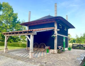 a blue play house with a roof on top at Het Westende in Rouveen