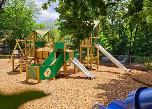 a playground with a slide in a park at Durbuy Bungalow 194, calme et nature in Durbuy