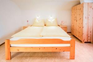 a bedroom with a wooden bed in a room at Ferienwohnung Haus Waldheim in Werfenweng