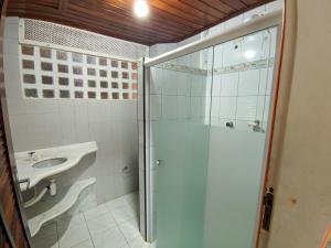 a bathroom with a shower and a sink at Casa de Praia Aconchegante in Peruíbe