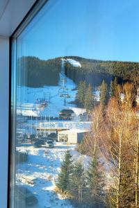 a view of a ski resort in the snow at Apartament Biała Perła Czarna Góra Resort in Sienna