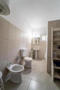 a bathroom with a toilet and a sink at Casona en Balneario Santa Ana in Santa Ana