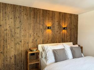 a bedroom with a bed and two lights on the wall at Alpenblick in Brixen im Thale