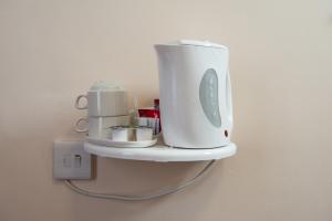 a white appliance is on a shelf on a wall at Dover Hotel - B&B in London +34 photos