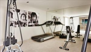 a room with a gym with a mirror and two exercise bikes at The Pearl of Jan Thiel villa with private pool gym and game room in Willemstad