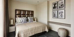 a bedroom with a large bed and pictures on the wall at The Pearl of Jan Thiel villa with private pool gym and game room in Willemstad +35 photos