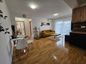 a living room with a couch and a table at OnPoint Apartmani in Osijek