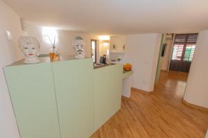 a kitchen with a counter with masks on top of it at Maison Castro Casetta a Palermo in Palermo