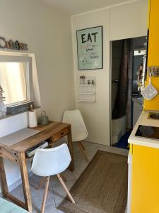 a kitchen with a wooden table and a white chair at Lucky Star Apartments in City Center in Split +16 photos