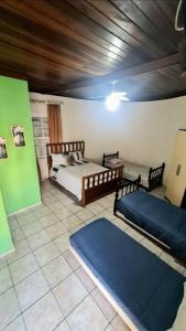 a bedroom with two beds in a room at Posada Verde Balneario Caragua in Caraguatatuba +7 photos