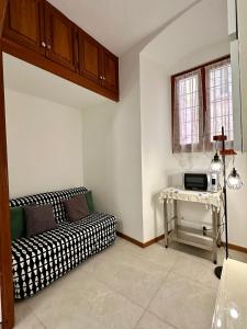 a living room with a couch and a table at Porto Vecchio Apartment in Sanremo