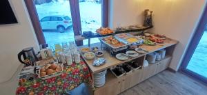 a table with a buffet of food on it at Vučja reka in Crni Vrh
