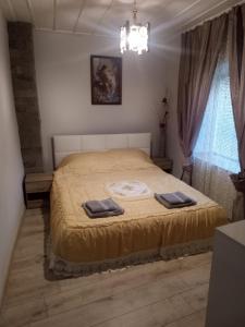 a bedroom with a bed with two towels on it at Стаи за гости VIVIA in Veliko Tŭrnovo