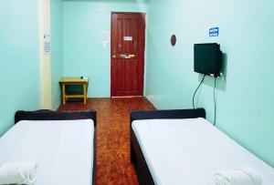 Postel nebo postele na pokoji v ubytování RedDoorz at D128 Lodge Cagayan Valley